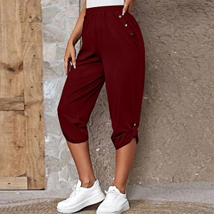 Detail view of dark red cropped casual pants with elastic high waist and silver buttons