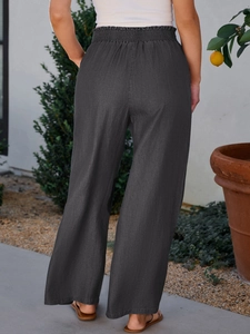 Detailed macro view of high-waisted wide-leg dark grey linen trousers with elastic waist