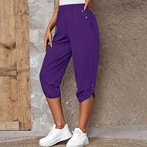 Close-up of deep purple capri pants featuring elastic waist and silver side button details