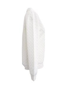 Close-up of white long sleeve sweatshirt with textured quilted checkerboard pattern design