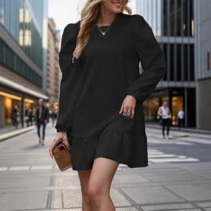 Chic black long sleeve quilted mini dress with ruffle hem and textured pattern