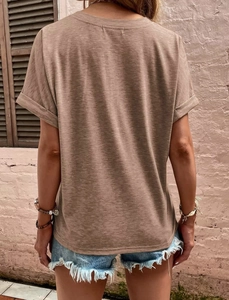 Detail of a brown short-sleeve t-shirt with rolled cuffs and a denim shorts back view