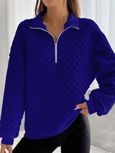 Detail of navy knit sweatshirt showing quilted waffle texture and half-zip collar
