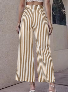 Detail of high waisted vertical striped wide leg pants with elastic waist and slit design