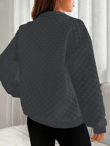 Detailed back view of dark grey waffle knit sweatshirt with dropped shoulders and ribbed cuffs