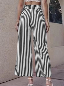 Back view of high waisted wide leg pants featuring black and white vertical stripes