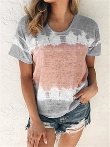 Close-up of grey and peach pink tie-dye pattern on women's loose casual summer T-shirt