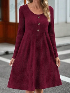 Detail of burgundy ribbed dress featuring a round neckline and three vintage buttons