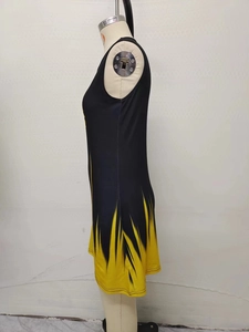 Detail view of sleeveless black dress featuring vibrant yellow abstract flame print patterns