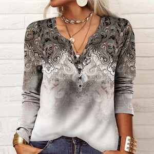 Detail of V-neckline with buttons on women's long sleeve top with paisley print