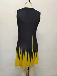 Detail of black sleeveless dress featuring dynamic yellow flame gradient print on the hem