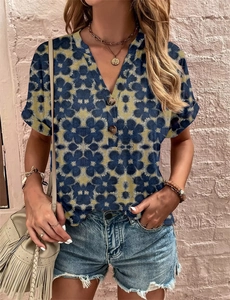 Detail of V-neckline floral print short sleeve blouse with decorative wooden buttons