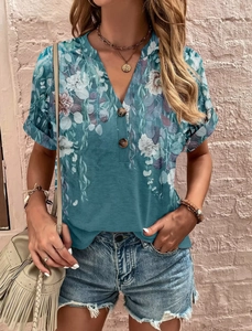 Detail of V-neck short sleeve top with floral print and decorative wooden buttons