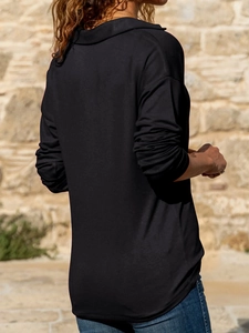 Detail view of the back of a casual black long-sleeve knit top with a classic lapel collar