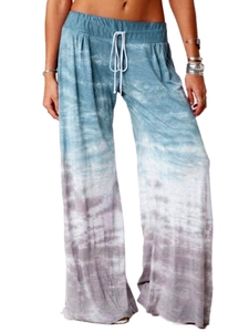 Detail of gradient tie-dye wide-leg yoga pants featuring a white drawstring waistband