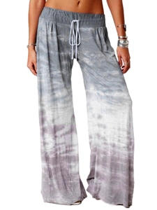 Detail of high waist tie-dye wide leg yoga pants with functional white drawstring