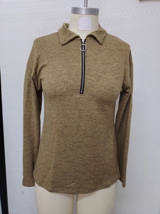 Macro shot of brown melange knit sweater featuring a silver ring zipper and polo collar