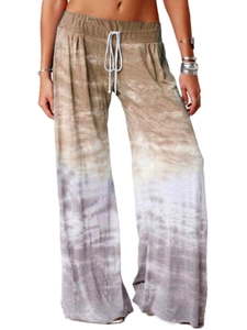Detailed view of women's wide leg yoga pants with gradient tie-dye and white drawstring