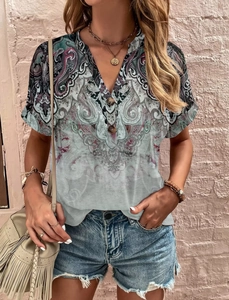 Close-up of V-neck button detail on a summer short sleeve blouse with paisley floral print