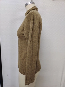 Detailed macro view of camel knit texture and stand collar zipper design on autumn sweater