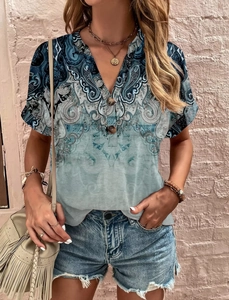 Detail view of V-neck blue paisley print summer blouse with dark decorative buttons