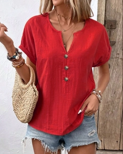 Close-up of red cotton linen T-shirt featuring a notched V-neck and vintage buttons