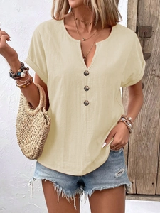 Detail view of V-neckline with wooden buttons and rolled sleeves on beige cotton t-shirt