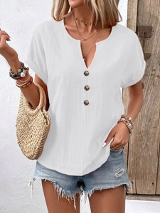 Detail of white V-neck short sleeve shirt with dark buttons and textured fabric