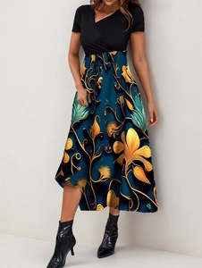 Detail of V-neck wrap bodice and A-line skirt with golden floral prints on maxi dress