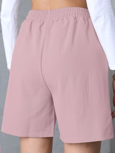 Rear view of pink high-waisted linen shorts with elastic waistband and relaxed fit