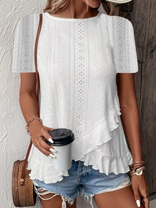 Close-up of white short-sleeved top featuring intricate eyelet embroidery and ruffle details