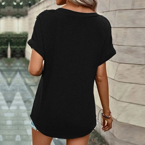 Detail of black short-sleeve T-shirt featuring decorative shoulder buttons and rolled cuffs