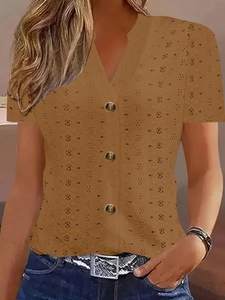 Detail of V-neck short sleeve shirt with eyelet embroidery and retro metal buttons