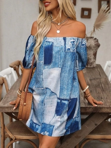 Detail of off-shoulder mini dress with blue patchwork print and puff lantern sleeves