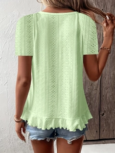 Detail of light green short sleeve T-shirt with eyelet embroidery and ruffle hem back view