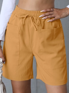 Detailed view of women's linen high-waisted shorts featuring elastic drawstring and cargo pockets