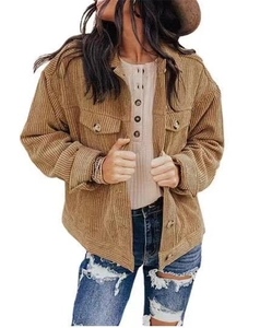 Detail of tan corduroy shirt jacket featuring dual flap pockets and ribbed texture