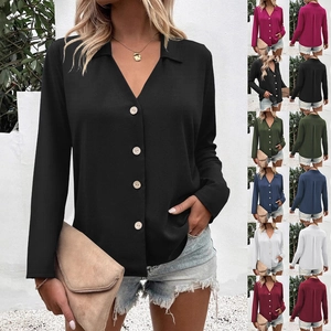 Detail showing the wood-textured buttons and V-neckline on the solid color women blouse