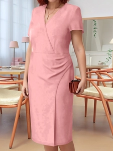 Detail of pink wrap dress featuring V-neckline and elegant side pleat draping style