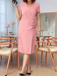 Detailed view of pink V-neck short sleeve dress with side pleats and wrap design