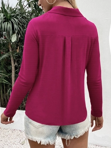 Detail of elegant magenta long sleeve shirt with back pleat and curved hem on a model