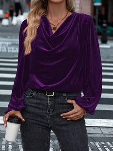 Detail of dark purple velvet long-sleeve top featuring a stylish draped cowl neckline