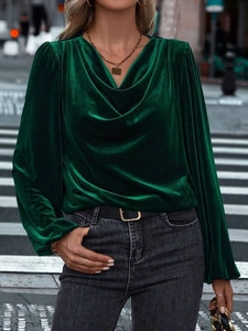 Detailed view of emerald velvet long sleeve top with elegant cowl neck and gathered cuffs