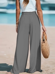 Vista posteriore dei pantaloni grigi a vita alta a gamba larga con drappeggio