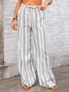 Close-up of elastic drawstring waistband on white and gray striped wide-leg linen pants
