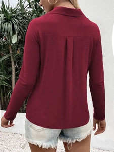 Back view of wine red long sleeve shirt featuring a central box pleat and elegant drape