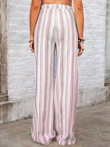 Rear view of striped wide-leg pants in pink and green with a comfortable elastic waist
