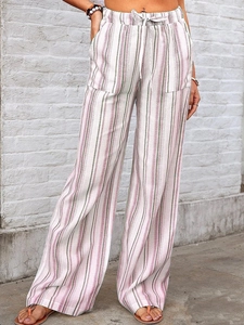 Detail showing elastic drawstring waistband and large square pockets on striped trousers