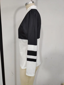 Side view of a black and white long sleeve shirt with striped sleeve details on a form