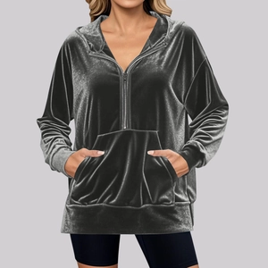 Detail of grey velvet hoodie featuring half-zip neckline and adjustable drawstring hood